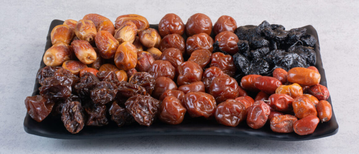 Dry fruit combination on a platter on concrete background